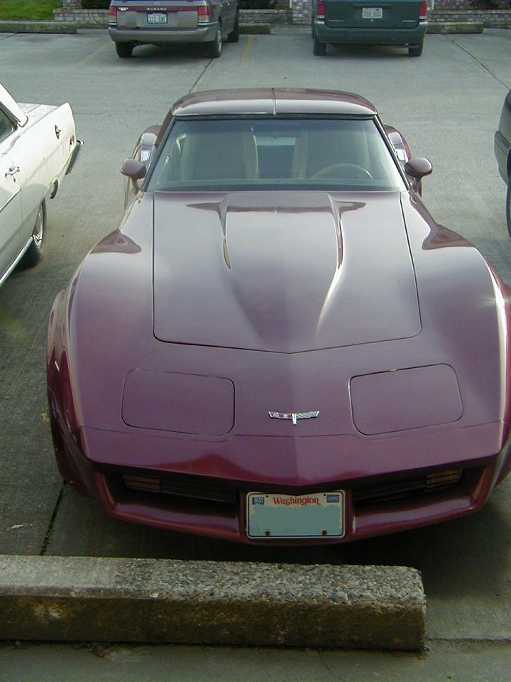 Maroon Chevrolet Corvette front view, parked, with Washington license plate