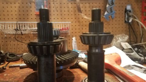 1985 Ford Bronco - Differential gears and pinion shafts are laid out on a workbench, possibly for repair or upgrade.