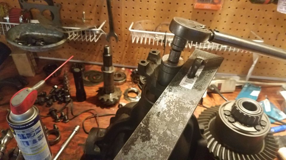 Differential gears and tools on a workbench with a ratchet