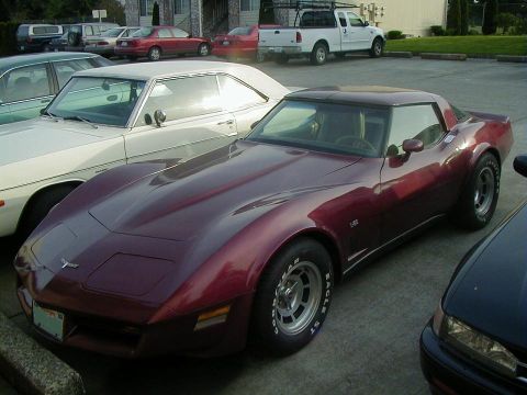 1993 Ford Bronco - A maroon Chevrolet Corvette C3 is parked next to other vehicles. The car features Eagle ST tires.