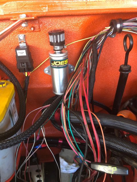 1992 Jeep Wrangler - Close-up of engine bay wiring and components, including a JOES Racing Products canister and a yellow battery.