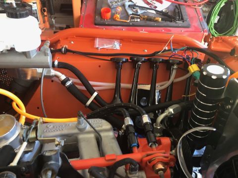 1992 Jeep Wrangler - Close-up view of an engine bay, highlighting the fuel rail, intake manifold, and various hoses and components during reassembly.