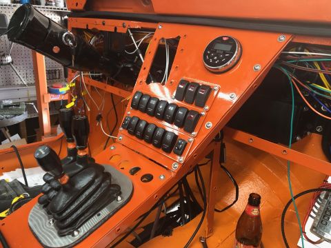 1992 Jeep Wrangler - The interior features a custom-built dashboard with numerous switches and two gear shifters, along with visible wiring.