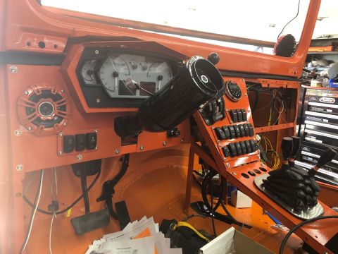 1992 Jeep Wrangler - The interior of a vehicle features a custom dashboard with aftermarket gauges and a panel of numerous switches.