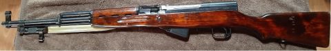 2003 Ford F-250 - A side profile of an SKS rifle, a wooden stock and an attached bayonet.