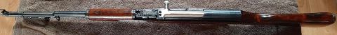 2003 Ford F-250 - A rifle with a wooden stock and metal components is shown from the side.