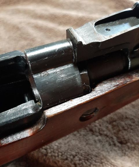 2003 Ford F-250 - Close-up of a firearm receiver showing metal components and a portion of the wooden stock.
