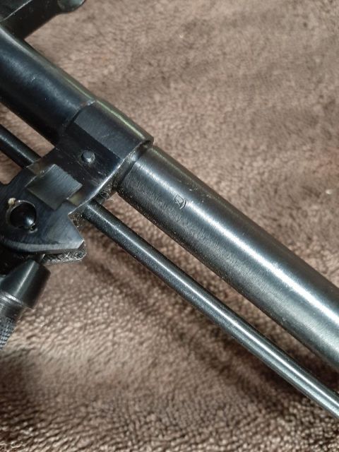 2003 Ford F-250 - A detailed view of a component, possibly from a firearm, showing some etched markings.
