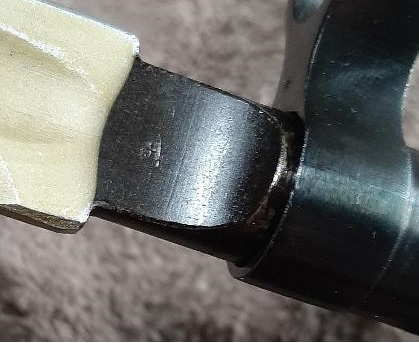 2003 Ford F-250 - A close-up view of a metal component, possibly from a vehicle, showing a stamped marking.