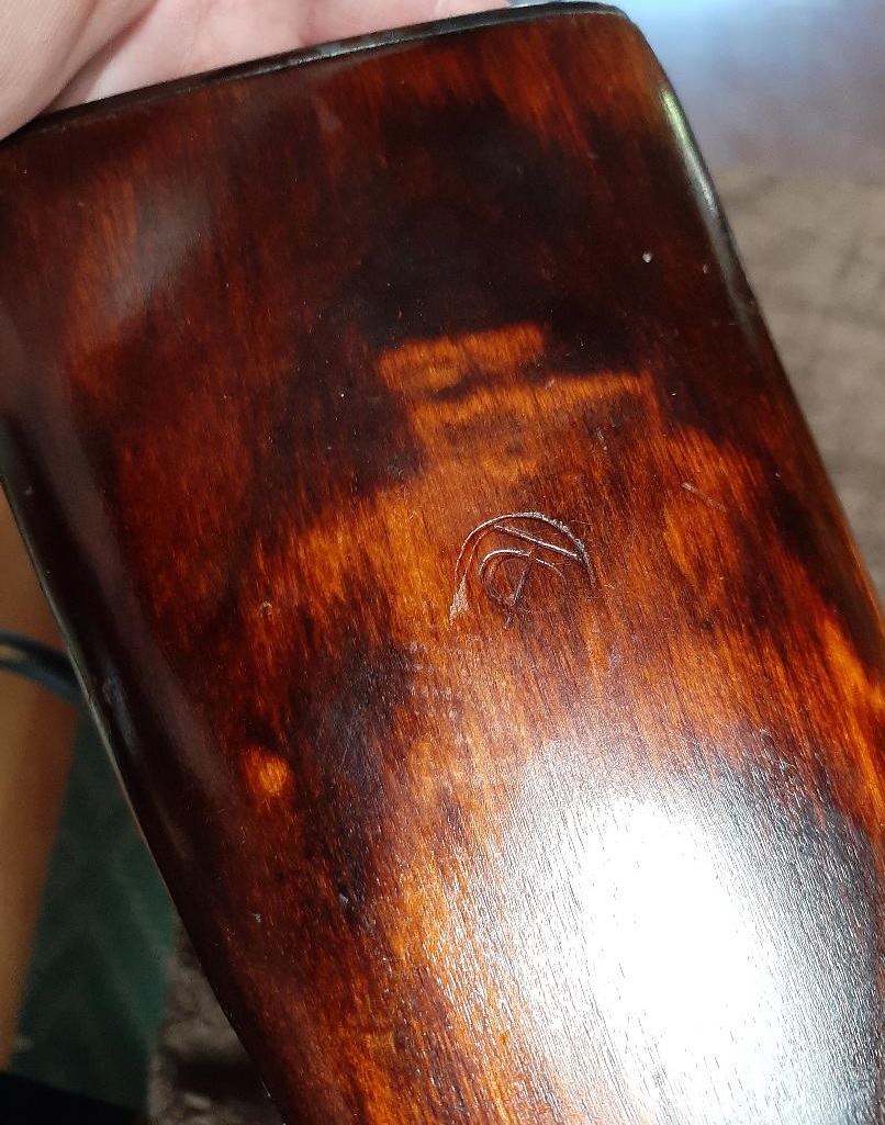 Wooden stock with circular emblem
