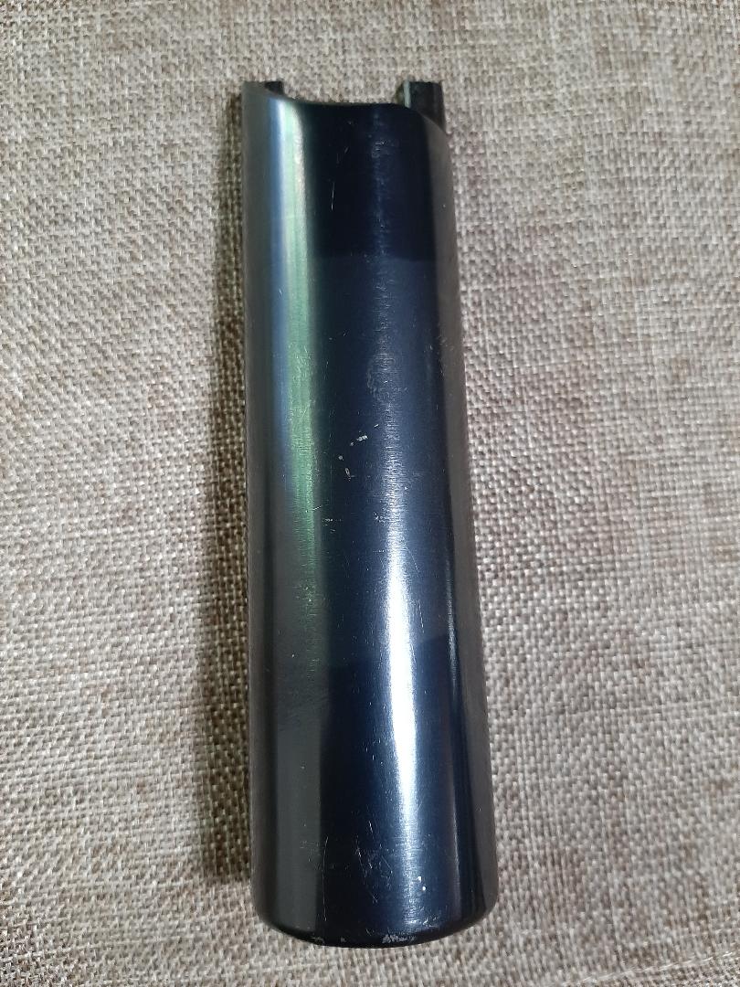 black plastic trim piece on a textured surface. Supermotors.net logo visible