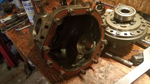 1985 Ford Bronco - Differential housing and gears disassembled on a workbench, likely for repair or maintenance.