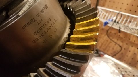 1985 Ford Bronco - Close-up of a differential gear showing wear marks and stamped part numbers.