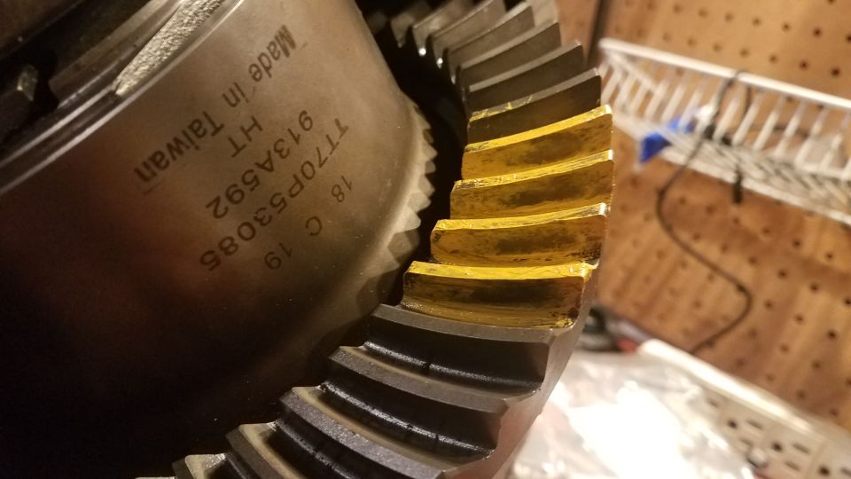 Differential gear with yellow markings on teeth, part number T770P53085 stamped on housing