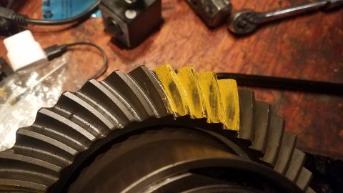 1985 Ford Bronco - Close-up of a differential gear showing yellow paint applied to the teeth, likely for marking during setup or inspection.