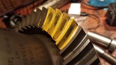 1985 Ford Bronco - Close-up of a differential gear showing wear pattern and part number FF70P53.
