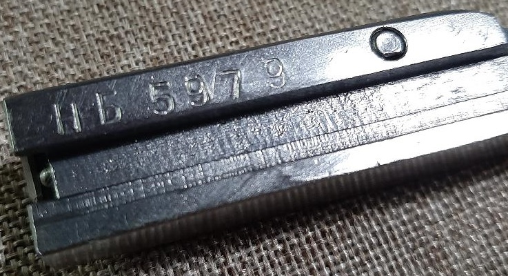 Metal part with stamped numbers HB 5979