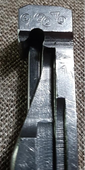 2003 Ford F-250 - Close-up of a metal part showing stamped markings, including the year 2002.
