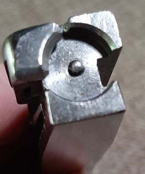 2003 Ford F-250 - A close-up view of a metal door lock actuator mechanism, showing intricate internal components.