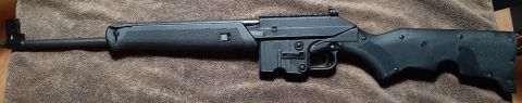 2003 Ford F-250 - A Keltec Sub 2000 rifle is shown from the side on a textured background.