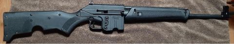 2003 Ford F-250 - A Kel-Tec SUB-2000 carbine is shown from the side, displaying its black polymer construction and metallic components.