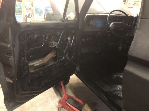 1978 Ford Bronco - The interior of a 1978 Ford Bronco is visible, with the driver's side door panel removed.