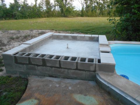 1992 Ford Bronco - Construction of a pool and surrounding concrete block area is underway.