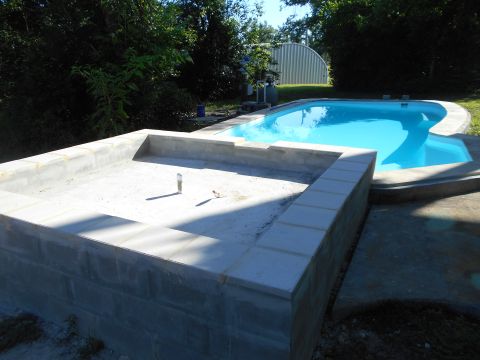 1992 Ford Bronco - A swimming pool is under construction, with concrete walls and a blue water-filled section visible.