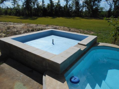 1992 Ford Bronco - Two swimming pools, one square and one kidney-shaped, are shown empty in a backyard setting.