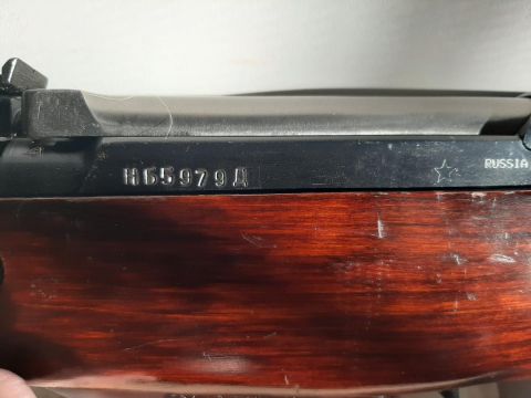 2003 Ford F-250 - Close-up view of a rifle receiver, displaying a serial number and country of origin.