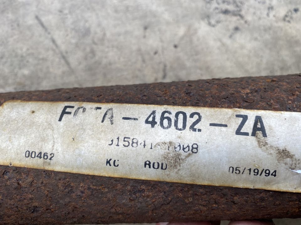Rusty metal rod with part number FOTA-4602-ZA and date 05/19/94.