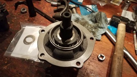 1985 Ford Bronco - A close-up view of a vehicle part, likely a hydraulic pump or motor housing, with a splined shaft protruding from the center. The part is r…