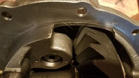 1985 Ford Bronco - Close-up view of the internal gears and housing of a differential assembly. The metal components show signs of wear and some fine debris is…