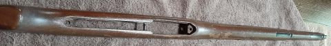 2003 Ford F-250 - This is a close-up, overhead shot of a wooden rifle stock that appears to be in a state of disrepair or restoration. The stock is brown wit…