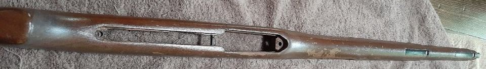 Wooden rifle stock with wear and discoloration
