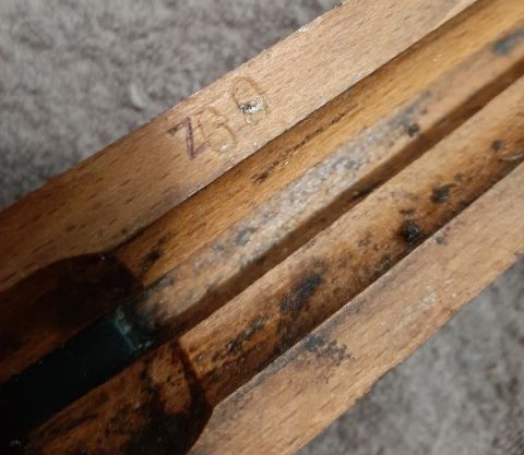 2003 Ford F-250 - Close-up shot of a wooden object with some markings on it. The object appears to be part of a larger item, possibly a tool or a component o…