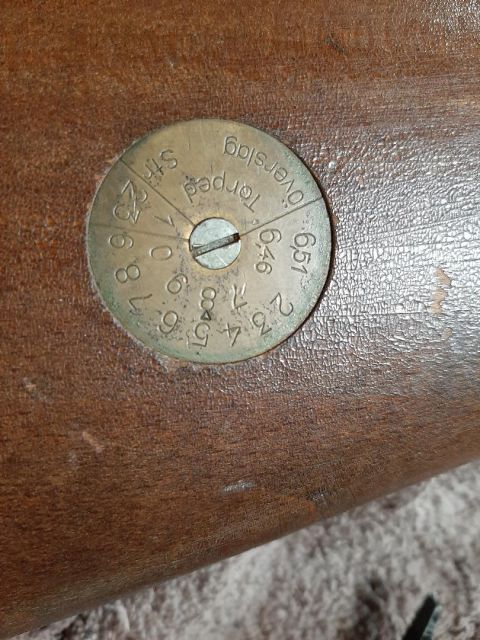 2003 Ford F-250 - A close-up of a brass dial with numbers and text is set into a wooden surface. The dial has divisions and markings, with some text visible…