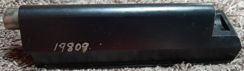 2003 Ford F-250 - A black metal part with the number "19809." etched into it is shown lying on a textured surface. The part appears to be a component of a ve…