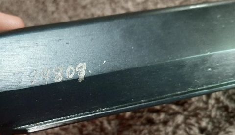 2003 Ford F-250 - A close-up view shows a serial number stamped onto a dark-colored metal surface. The serial number appears to be "3944309."