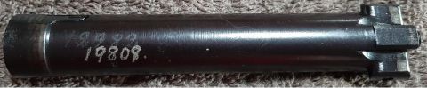 2003 Ford F-250 - A close-up view of a dark metal part with white markings that read "19809.". The part has a hexagonal end with two prongs extending from it.