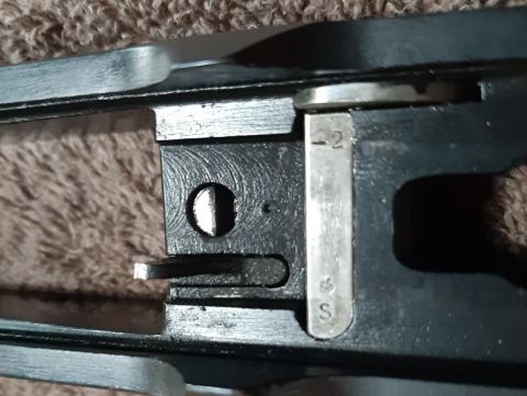 2003 Ford F-250 - A close-up view of a metal mechanism with markings indicating '-2' and 'S'. The part appears to be a component of a larger assembly, possib…