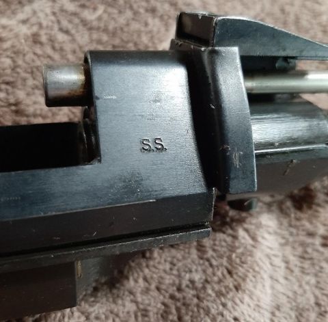 2003 Ford F-250 - A close-up of a metal part with "S.S." stamped on it. The part appears to be from a firearm or mechanical device.