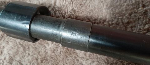 2003 Ford F-250 - A close-up view of a metal barrel, possibly part of a firearm, showing a small circular marking with a symbol inside. The barrel is dark an…