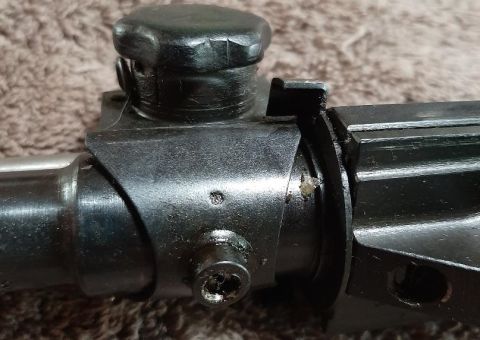 2003 Ford F-250 - This is a close-up shot of a metal part, possibly a component of a firearm, with a black knob on top and a screw visible below. The metal h…