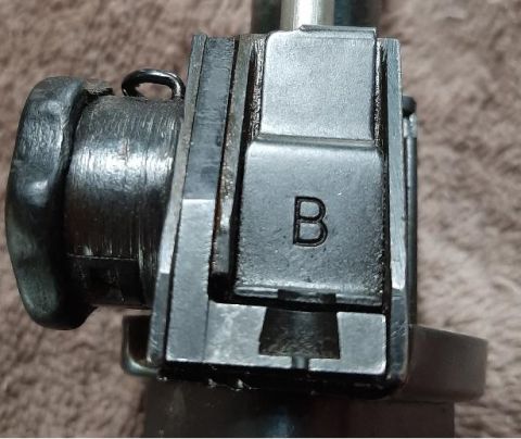2003 Ford F-250 - A close-up view shows a metal component with the letter "B" stamped on it. The part appears to be part of a mechanical assembly, possibly f…