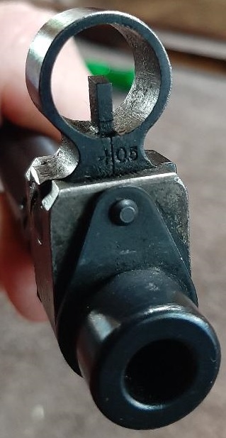 2003 Ford F-250 - A close-up view of the rear sight assembly and muzzle of a firearm.