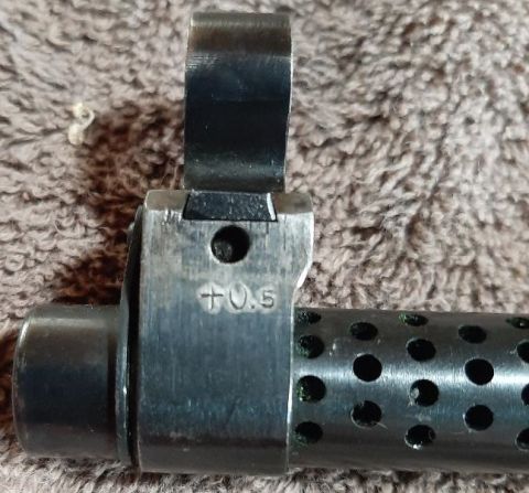 2003 Ford F-250 - A close-up view shows the front sight post and a portion of the barrel shroud of a firearm. Markings on the sight base read "+0.5".