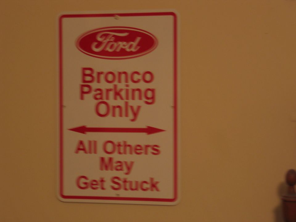 Ford Bronco parking sign with red text on white