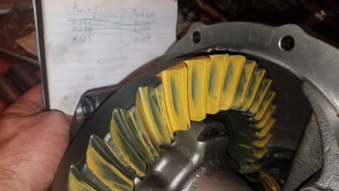 1985 Ford Bronco - A close-up view shows the teeth of a differential ring gear coated in yellow marking compound, indicating contact points. A handwritten not…
