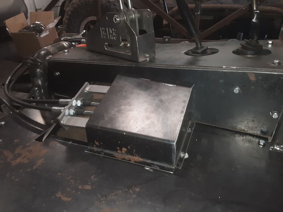 Custom vehicle interior with metal center console, shifters, and cables.